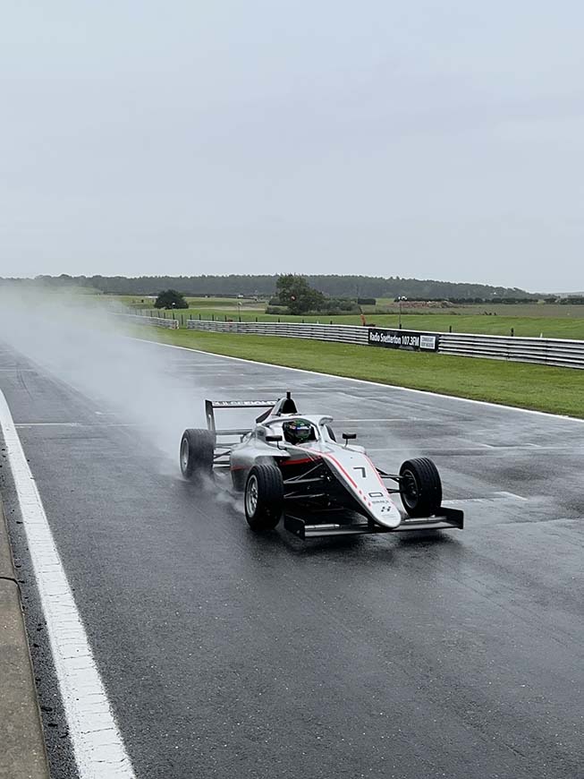 Chase Fernandez in car on the track